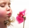 girl blowing pinwheel
